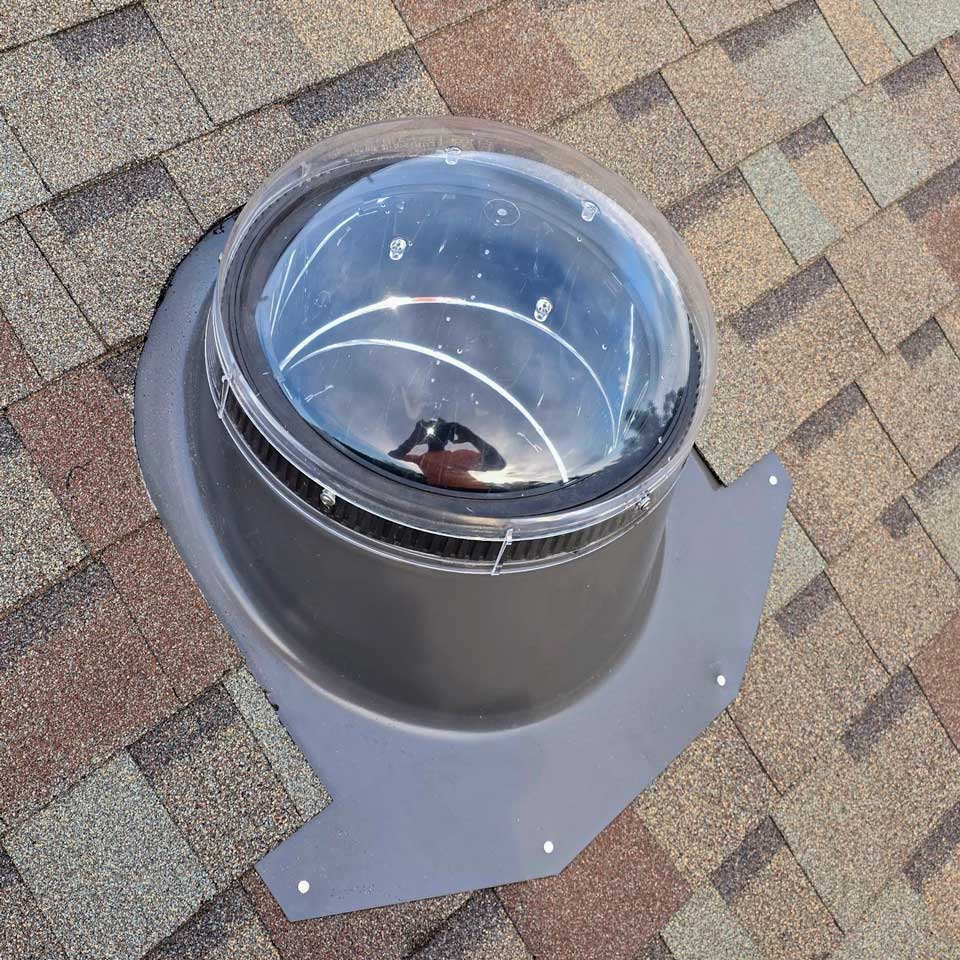 An exterior view of one Velux Sun Tunnel installed on the roof.