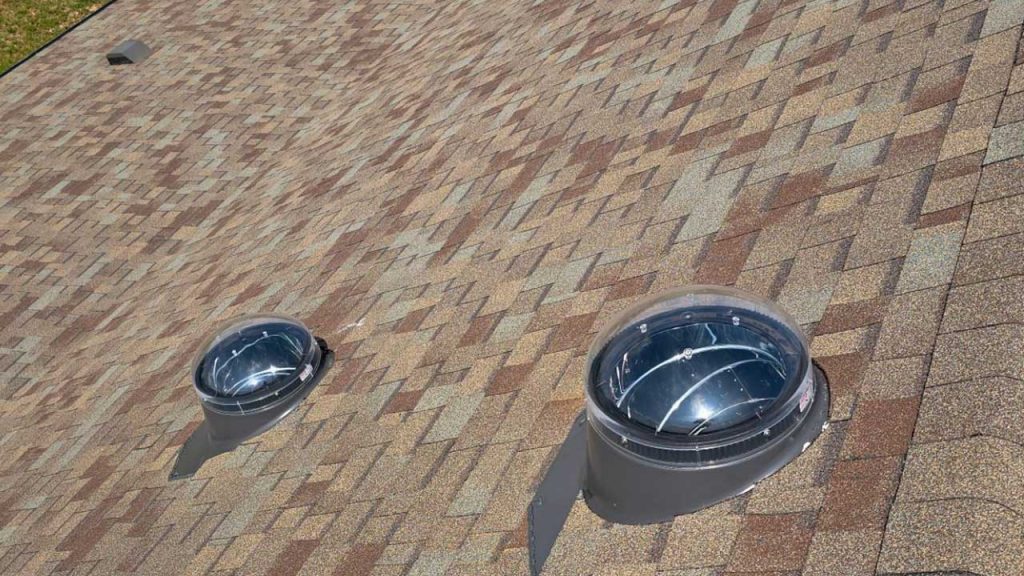 An exterior view of two Velux Sun Tunnels installed on the roof.