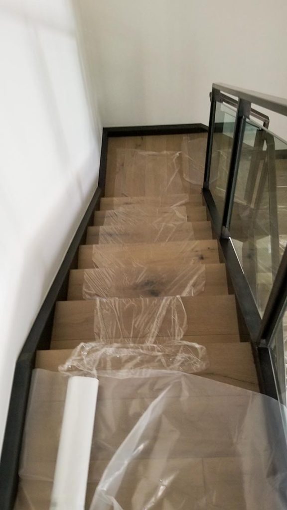 Plastic sheeting runner up the stairs keeps carpet clean.